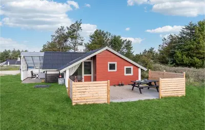 a small red house with a picnic table and a patio at Amazing Home In Thisted With Wifi in Thisted