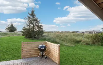 a grill sitting next to a wooden fence at Amazing Home In Thisted With Wifi in Thisted