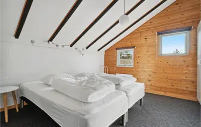 a room with four white beds in a wooden wall at Amazing Home In Thisted With Wifi in Thisted