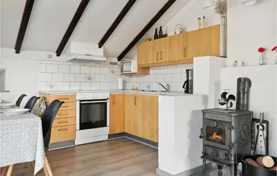 a kitchen with wooden cabinets and a stove at Amazing Home In Thisted With Wifi in Thisted