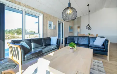 a living room with a couch and a table at Amazing Home In Thisted With Sauna in Thisted
