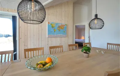 a dining room with a table with a bowl of fruit at Amazing Home In Thisted With Sauna in Thisted