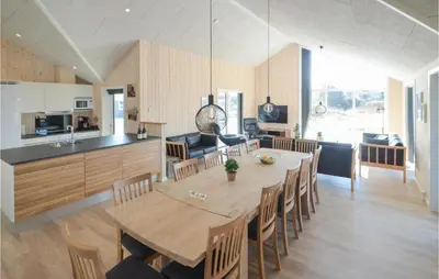 a dining room and kitchen with a table and chairs at Amazing Home In Thisted With Sauna in Thisted