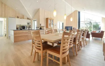 a kitchen and dining room with a wooden table and chairs at Amazing Home In Thisted With Sauna in Thisted