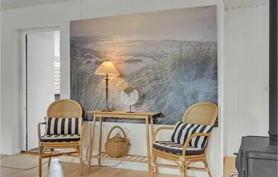 a dining room with a table and two chairs at 4 Bedroom Gorgeous Home In Blokhus in Blokhus