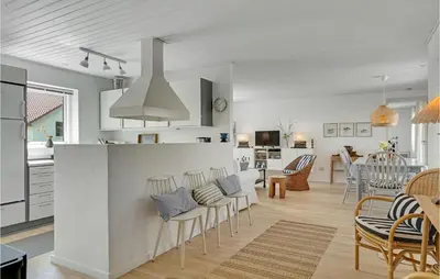 a kitchen and living room with a kitchen and dining room at 4 Bedroom Gorgeous Home In Blokhus in Blokhus