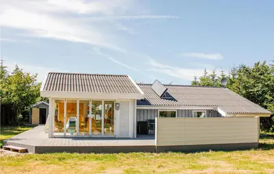 a small white house with a porch at Villa Mormor in Løkken