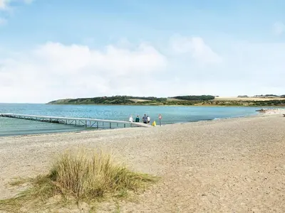 a group of people standing on a pier near the water at 4 person holiday home on a holiday park in Lemvig in Lemvig
