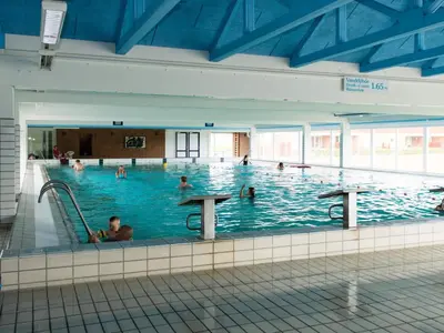 a large indoor swimming pool with people in it at 5 person holiday home on a holiday park in Lemvig in Lemvig