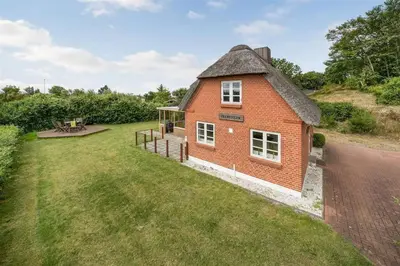 an aerial view of a red brick house with a yard at Thatched Holiday Home in Struer, Jutland with a view in Struer