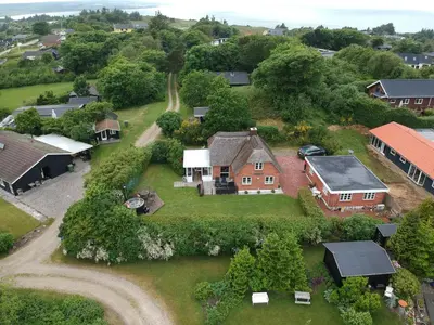an aerial view of a house with a yard at Thatched Holiday Home in Struer, Jutland with a view in Struer