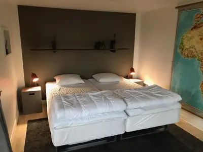 a bedroom with a large white bed with two pillows at Thatched Holiday Home in Struer, Jutland with a view in Struer