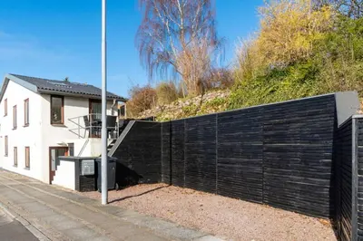 a black fence in front of a house at Marieshus in Holstebro
