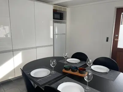 a black table with plates and wine glasses on it at Marieshus in Holstebro