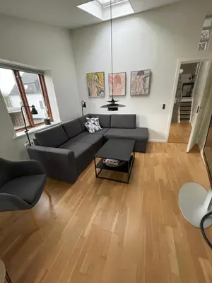 a living room with a couch and a table at Marieshus in Holstebro
