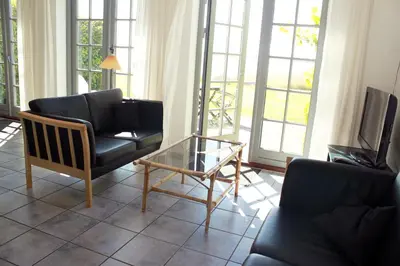 a living room with a couch and a glass coffee table at Skibstedgaard in Hurup