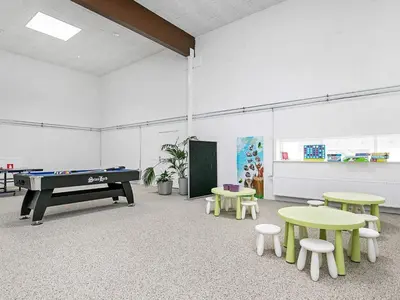 a room with a pool table and tables and chairs at 6 person holiday home in Brovst in Brovst