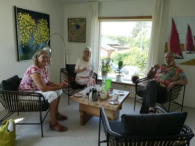 three people sitting in chairs in a living room at Værelse som dobbelt el. enkelt, Engen 5, 7770 Vestervig in Vestervig