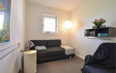 a living room with a couch and a window at Awesome Home In Holstebro With Kitchen in Holstebro