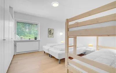 a bedroom with two bunk beds and a window at Awesome Home In Holstebro With Kitchen in Holstebro