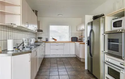 a kitchen with white cabinets and stainless steel appliances at Awesome Home In Holstebro With Kitchen in Holstebro