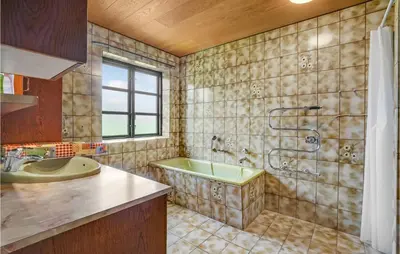 a bathroom with a tub and a sink at Gorgeous Home In Hanstholm With Kitchen in Hanstholm