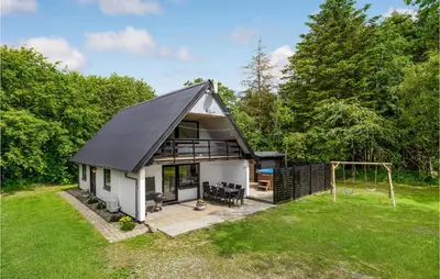 a house with a pitched roof and a playground at Cozy Home In Øster Assels With Sauna in Øster Assels
