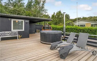 a deck with two chairs and a hot tub at Amazing Home In Roslev With Wifi in Roslev