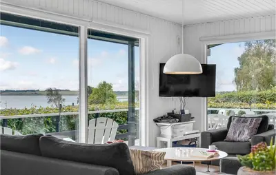 a living room with a view of the water at Amazing Home In Roslev With Wifi in Roslev
