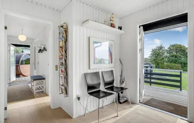 a black chair in a white room with a window at Amazing Home In Roslev With Wifi in Roslev