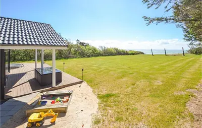 a backyard with a gazebo and a toy truck in the sandbox at Pet Friendly Home In Vinderup in Vinderup