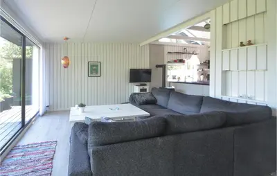 a living room with a couch and a table at Gorgeous Home In Fjerritslev in Fjerritslev