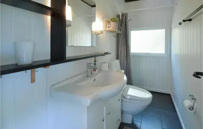 a white bathroom with a sink and a toilet at Gorgeous Home In Fjerritslev in Fjerritslev