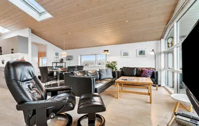 a living room with leather furniture and a table at Gorgeous Home In Harboøre With Wifi in Harboør