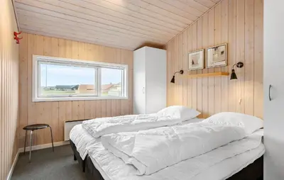 two beds in a room with a window at Gorgeous Home In Harboøre With Wifi in Harboør