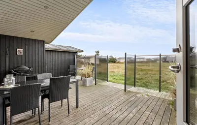 a patio with a table and chairs on a deck at Gorgeous Home In Harboøre With Wifi in Harboør