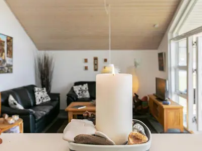 a candle sitting on a table in a living room at 6 person holiday home in Brovst in Brovst
