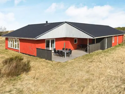 a red house with a black roof on a hill at Luxury Dunes Retreat-By Traum in Pandrup