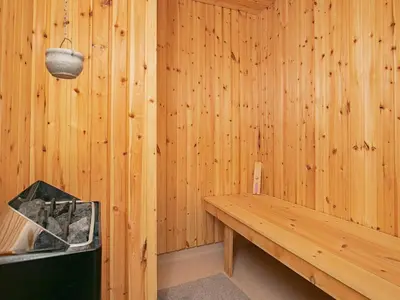 a wooden room with a bench in a sauna at Luxury Dunes Retreat-By Traum in Pandrup