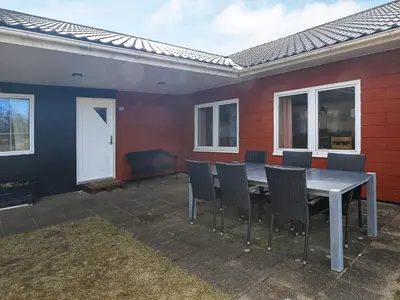 a table and chairs in front of a house at Luxury Dunes Retreat-By Traum in Pandrup