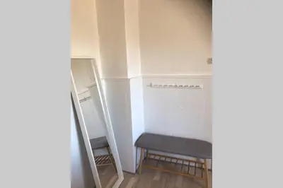 a small room with a bench and a ladder at Seaside VØ in Nørre Vorupør