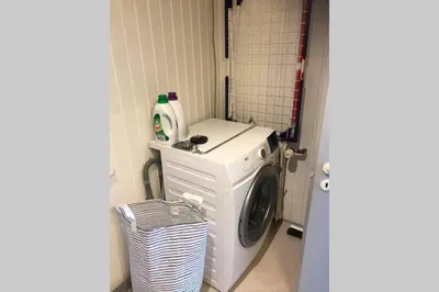 a washer and dryer in a small room at Seaside VØ in Nørre Vorupør
