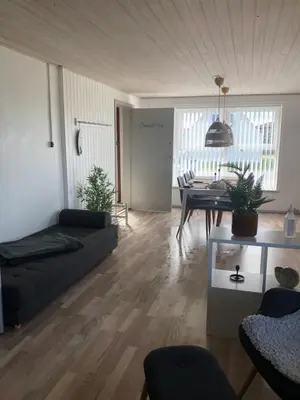 a living room with a couch and a table at Seaside VØ in Nørre Vorupør