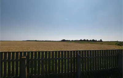 a fence with a field in the background at Awesome Home In Harboøre With Kitchen in Harboør