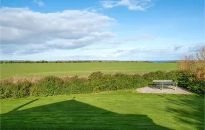 a picnic bench sitting in the middle of a field at Cozy Home In Vinderup With Wifi in Vinderup