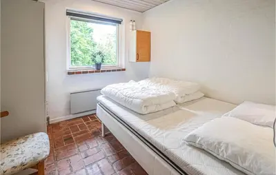 two beds in a room with a window at Cozy Home In Vinderup With Wifi in Vinderup