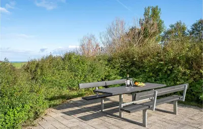 a picnic table with a drink and a plate of food on it at Cozy Home In Vinderup With Wifi in Vinderup