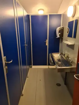 a bathroom with a blue door and a sink at Stoholm Vandrehjem in Stoholm