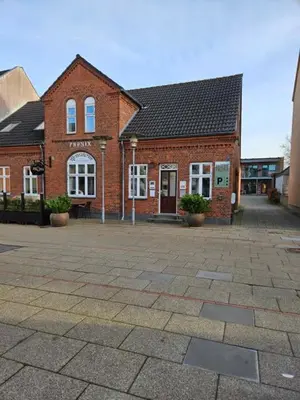 a brick building with a courtyard in front of it at Hotel Phønix in Holstebro