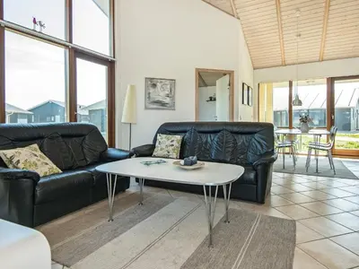 a living room with a couch and a table at Tranquil Retreat in Thorsminde-By Traum in Ulfborg